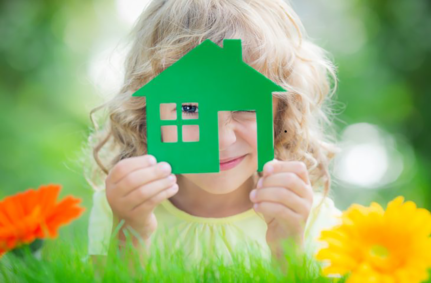 Enfant regardant à travers une maison verte en carton